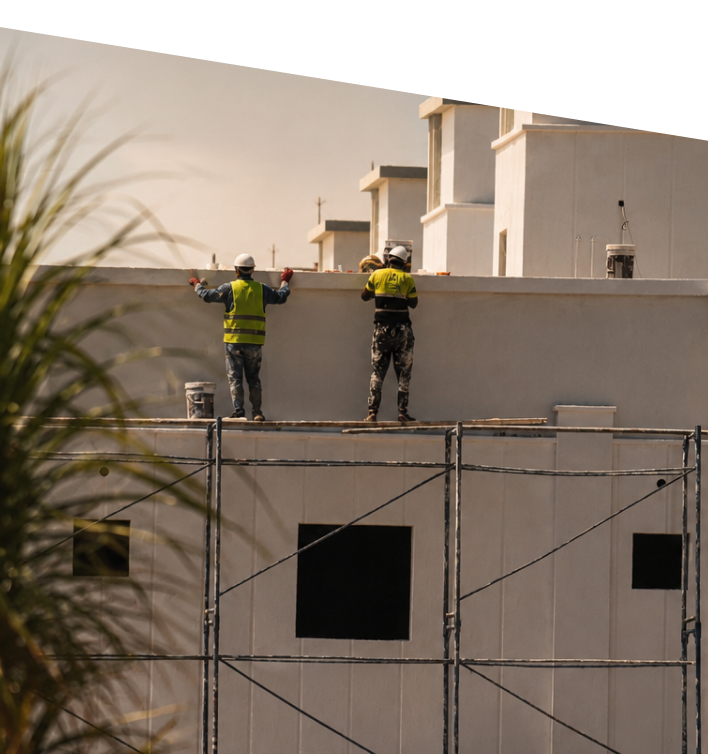Construction workers on scaffolding at a residential building site
